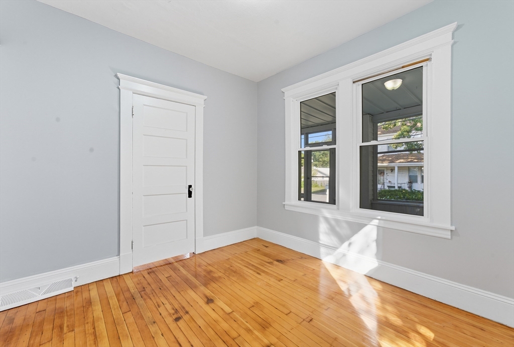 33 Taber Street Springfield, MA 01118 - Photo 16 of 39 a view of an empty room with wooden floor and a window