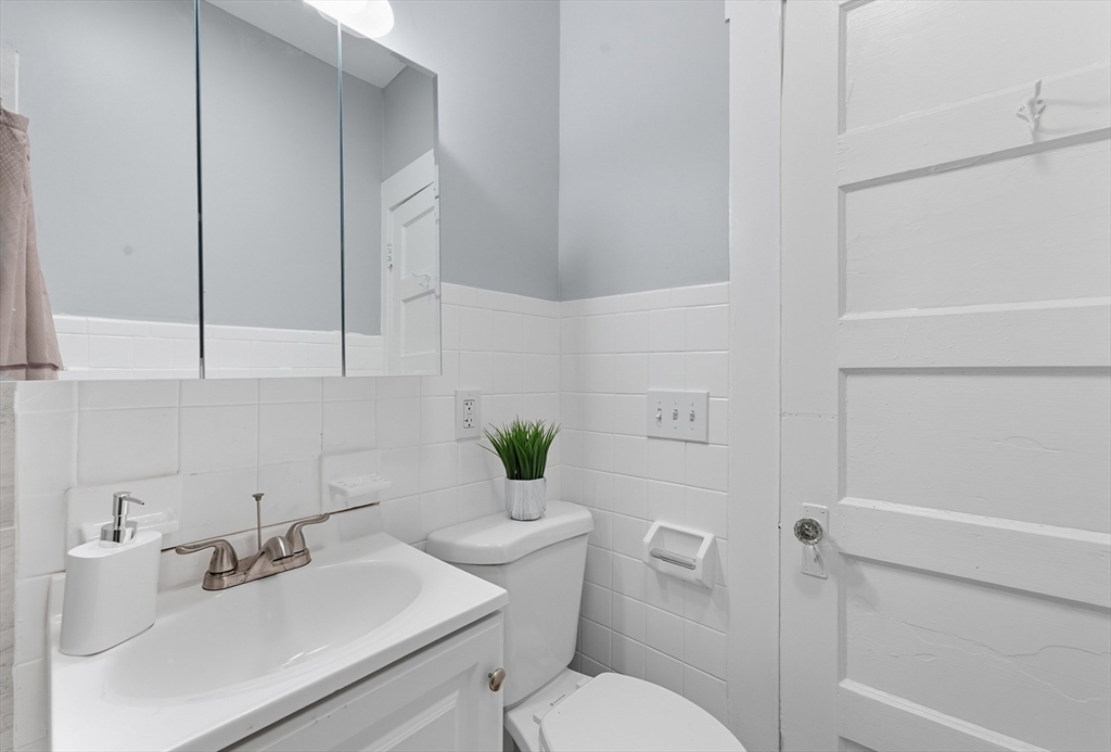 33 Taber Street Springfield, MA 01118 - Photo 19 of 39 a bathroom with a sink mirror and toilet