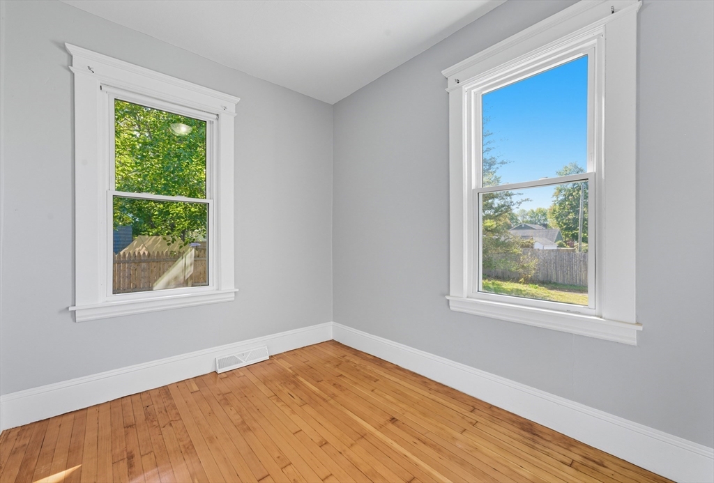 33 Taber Street Springfield, MA 01118 - Photo 22 of 39 a view of an empty room with wooden floor and a window