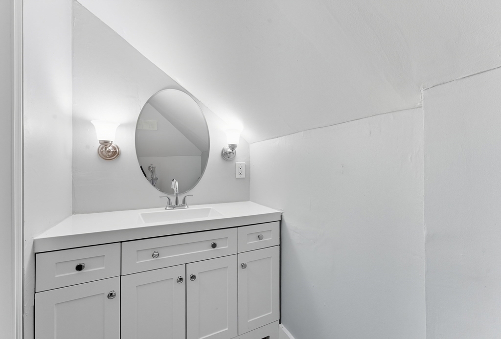 33 Taber Street Springfield, MA 01118 - Photo 27 of 39 a view of a mirror and cabinets in a room