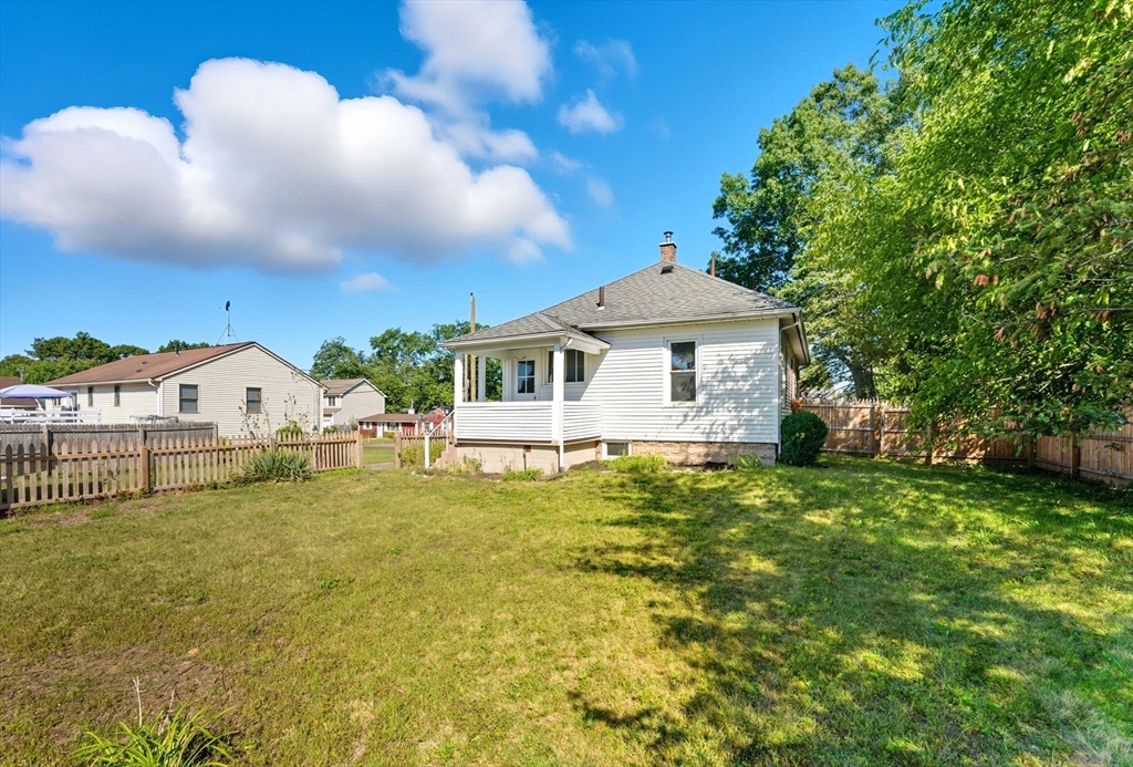 33 Taber Street Springfield, MA 01118 - Photo 33 of 39 a front view of a house with a yard garage and outdoor seating