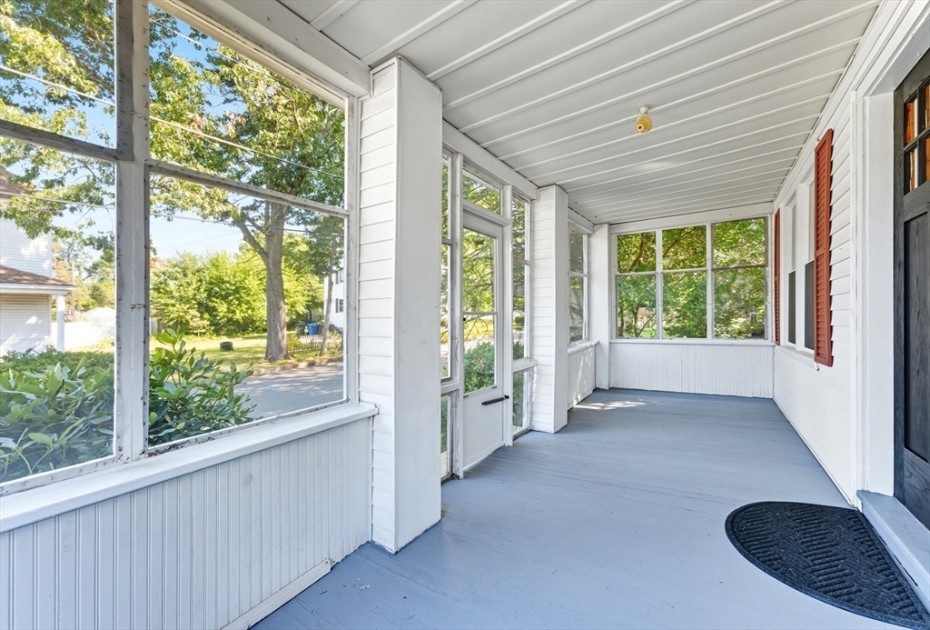 33 Taber Street Springfield, MA 01118 - Photo 6 of 39 a view of a porch with wooden floor and front of a house