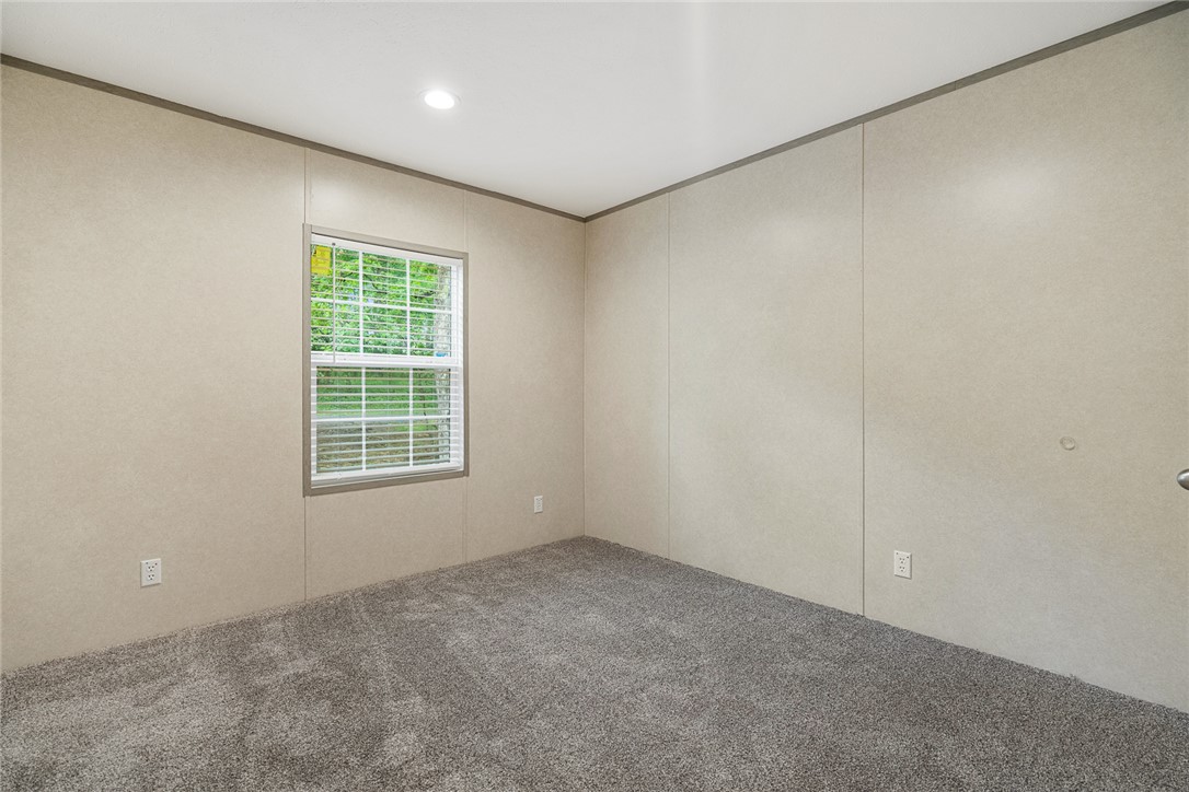 419 Austin Drive Anderson, SC 29624 - Photo 27 of 36 This bright bedroom features a window providing natural light and soft carpeting, creating a comfortable living space.