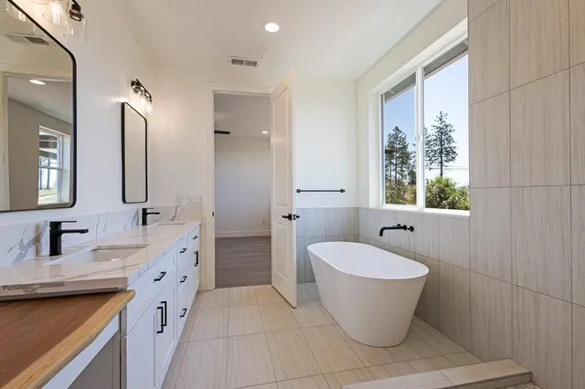 a bathroom with a granite countertop sink toilet a mirror and shower