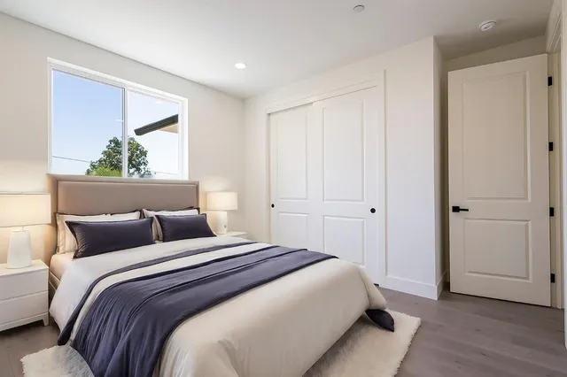 a bedroom with a bed and a painting on the wall