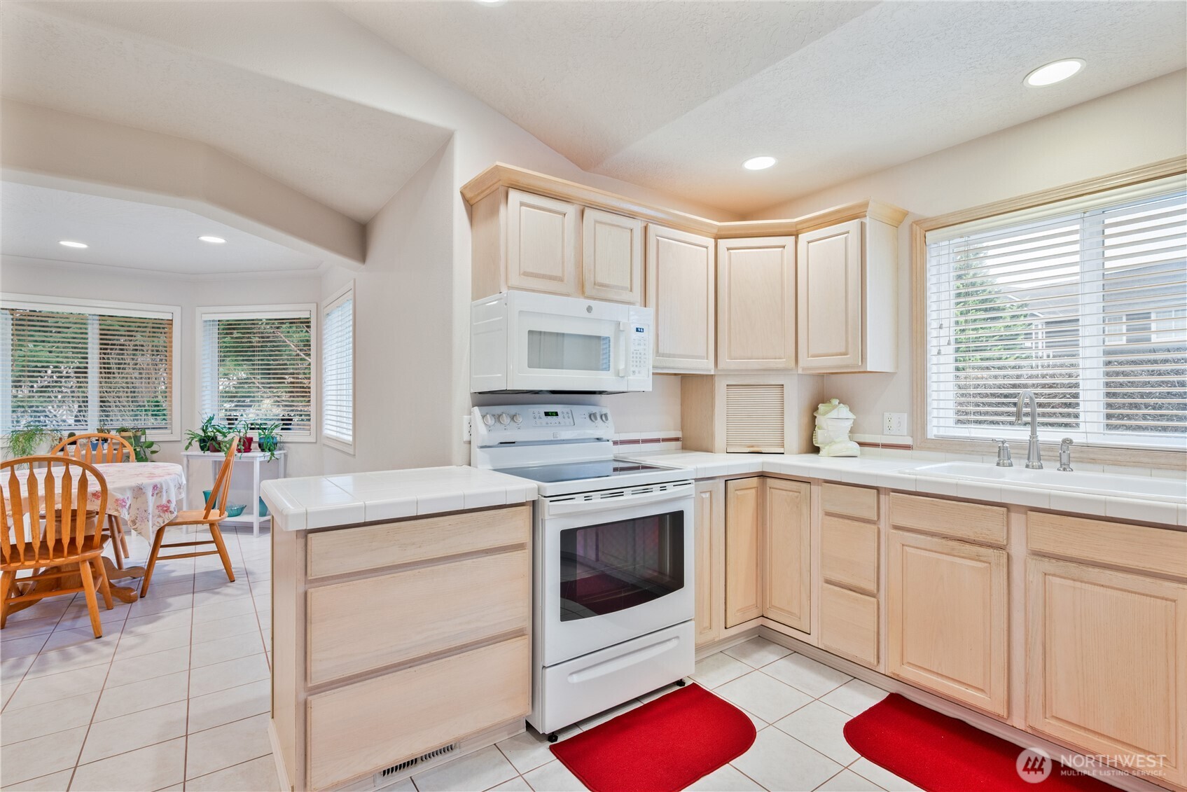 214 St James Court Longview, WA 98632 - Photo 8 of 40 a kitchen that has a lot of white cabinets and stainless steel appliances