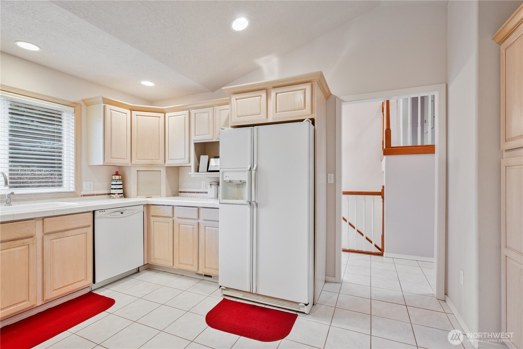 214 St James Court Longview, WA 98632 - Photo 9 of 40 a kitchen with white cabinets and refrigerator