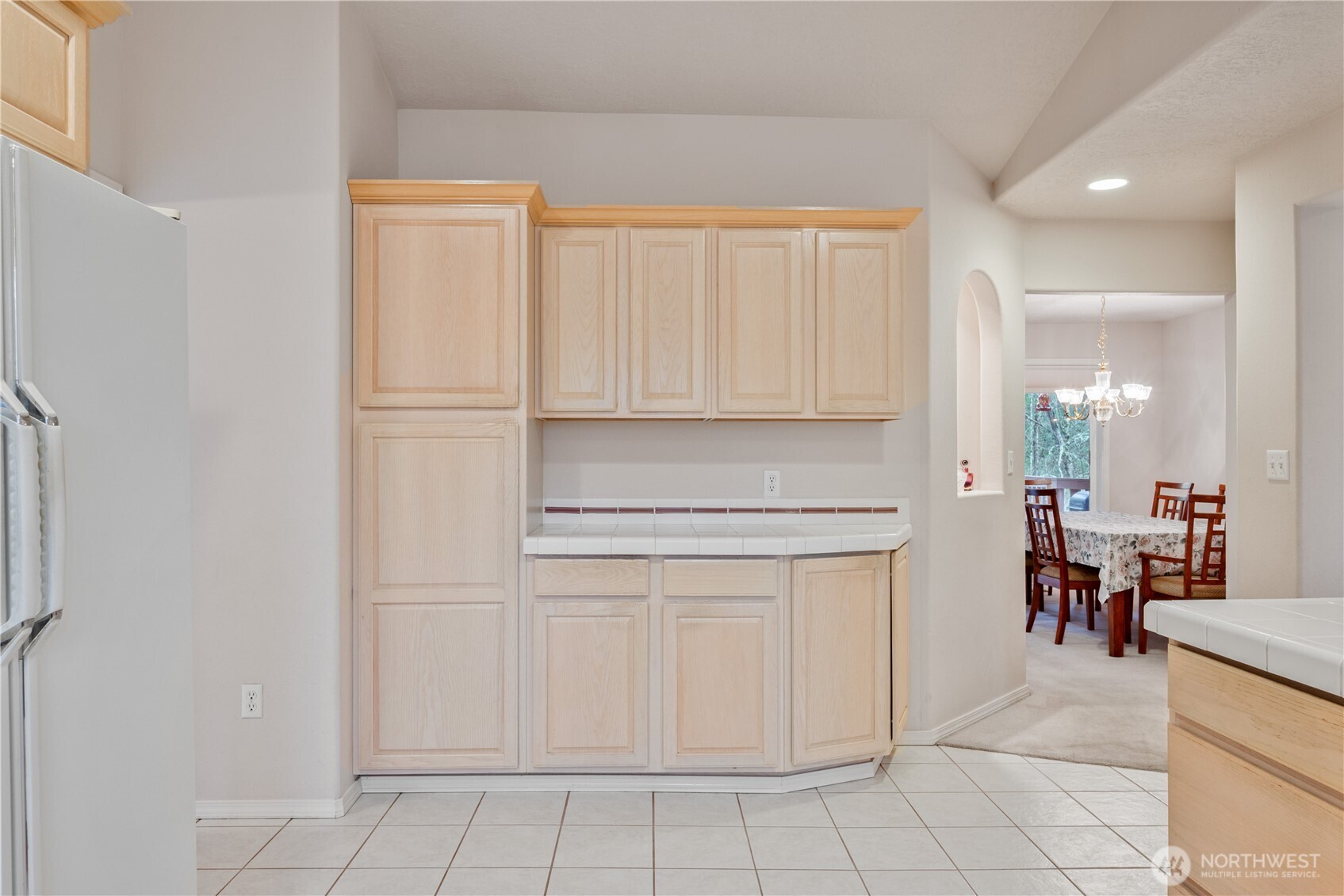 214 St James Court Longview, WA 98632 - Photo 10 of 40 a kitchen with white cabinets and white appliances