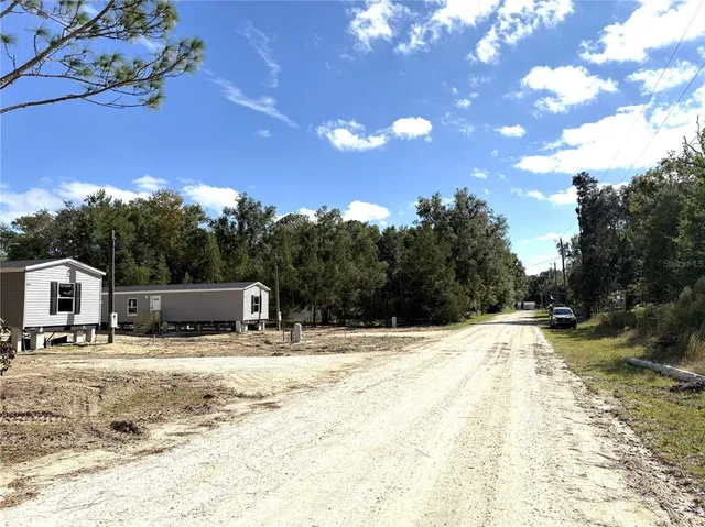 a view of a yard with snow on the road