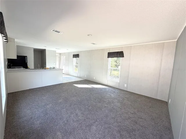 a view of a big room with windows and cabinet