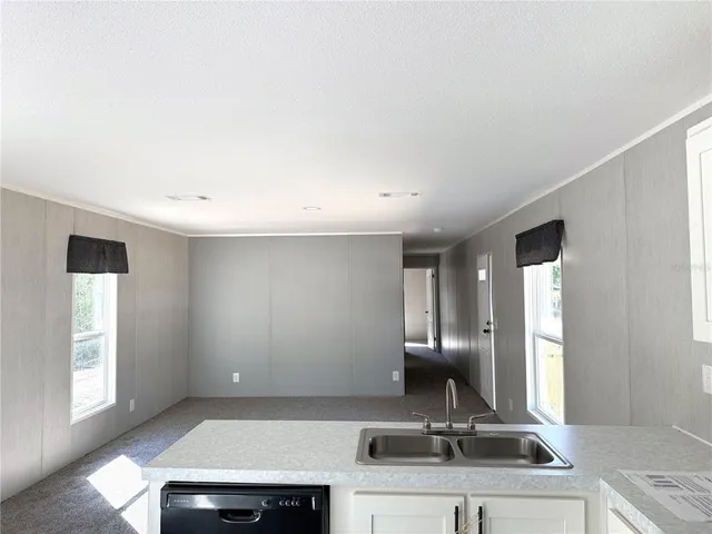 a view of a kitchen with a sink and a window