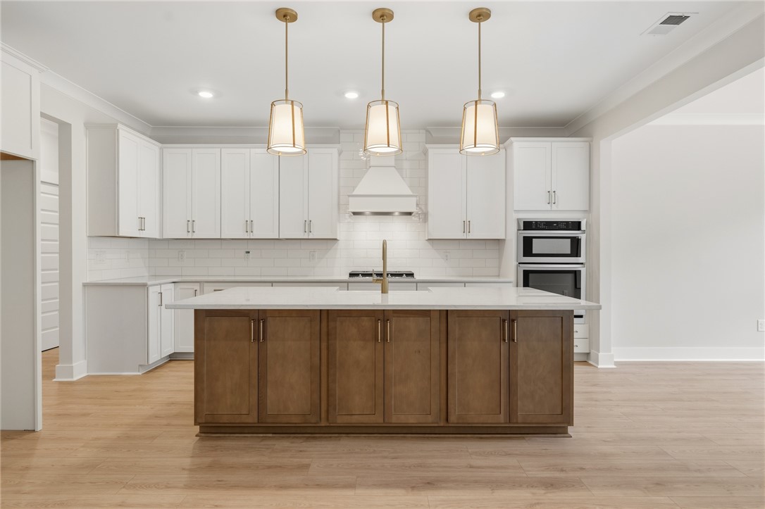 203 Timothy Court Anderson, SC 29621 - Photo 6 of 40 A spacious kitchen with an inviting island and overhead pendant lighting awaits culinary adventures.