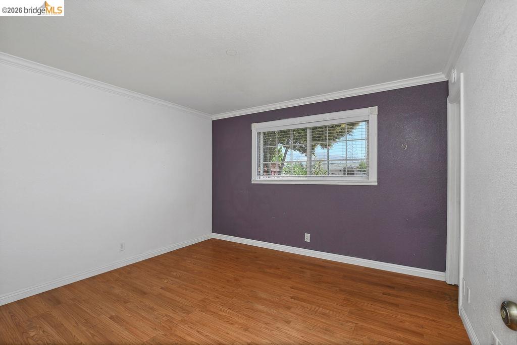 805 Calero Street Milpitas, CA 95035 - Photo 12 of 23 Interior room featuring wood-finish flooring, white baseboards, and crown molding