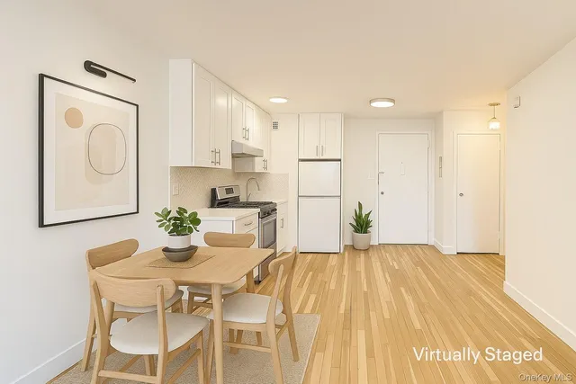 a kitchen with granite countertop a sink cabinets and stainless steel appliances