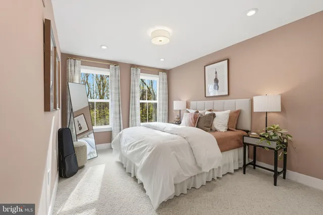 a spacious bedroom with a bed and a couch