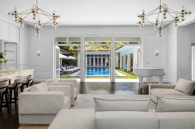 a living room with furniture a chandelier and a chandelier