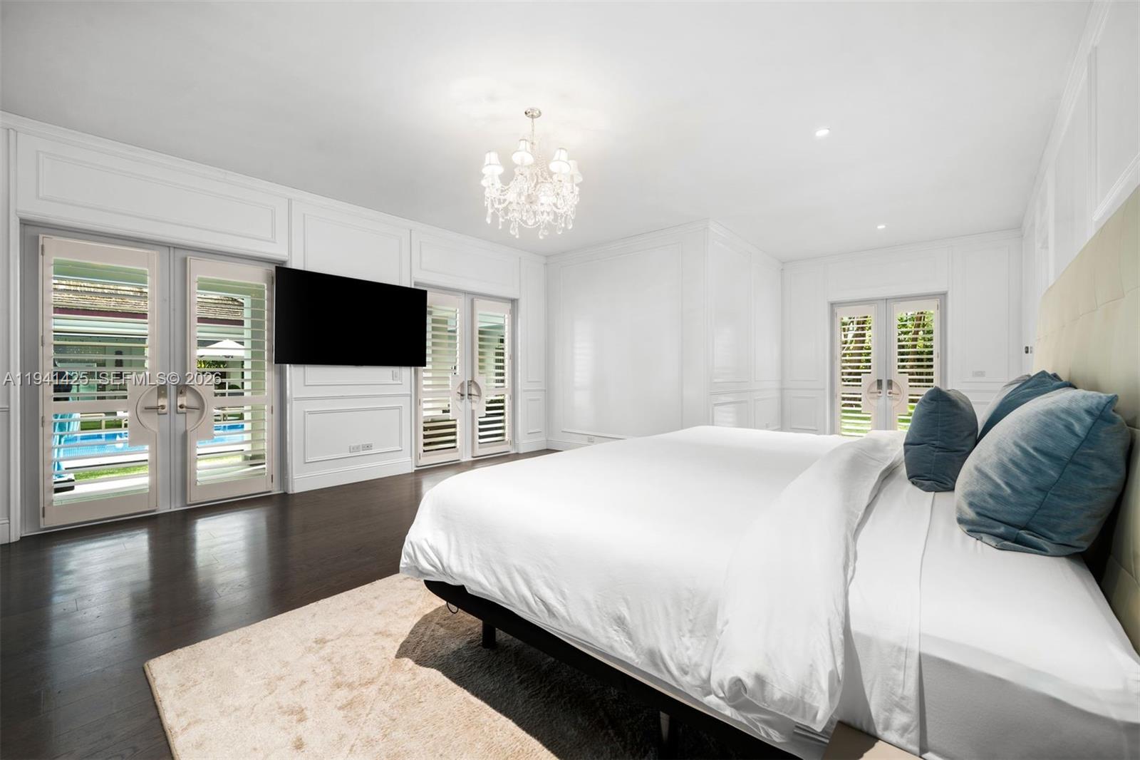 4100 Kiaora Street Miami, FL 33133 - Photo 7 of 26 a bedroom with a large bed and a flat screen tv