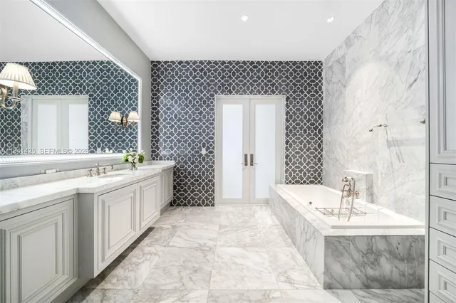 a bathroom with a tub a sink and mirror