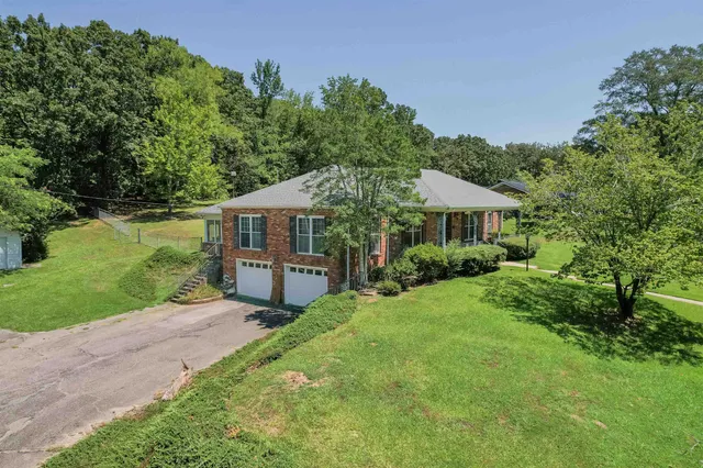 a front view of house with yard and green space