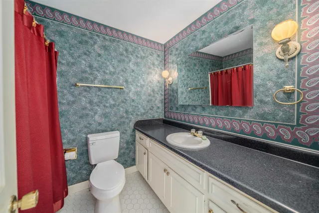 a living room with furniture a rug and a chandelier
