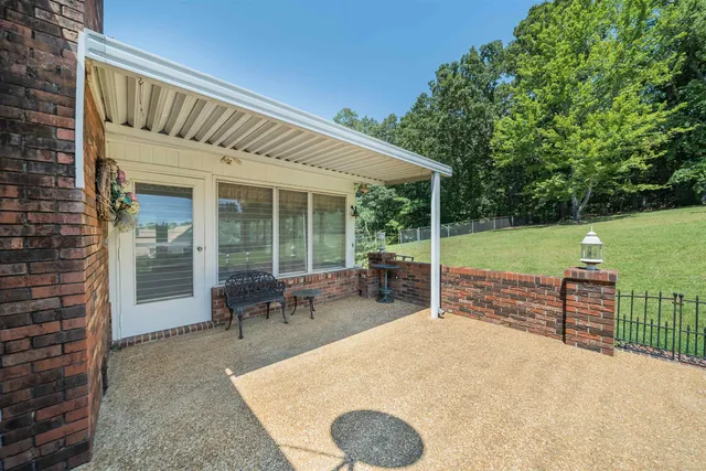a view of a house with backyard porch and sitting area