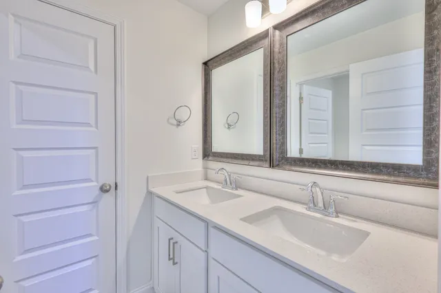 a bathroom with a double vanity sink and a mirror