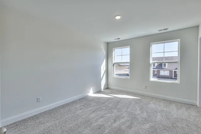 a view of an empty room and closet area