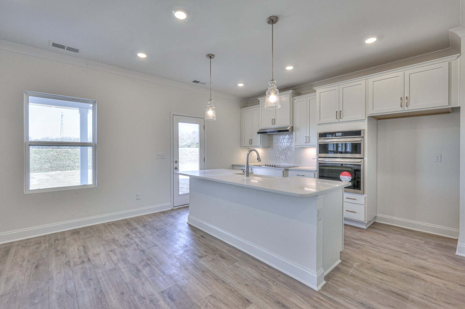 2269 Bluestem Road Columbia, TN 38401 - Photo 4 of 25 a kitchen with stainless steel appliances granite countertop a sink dishwasher a refrigerator and white cabinets with wooden floor
