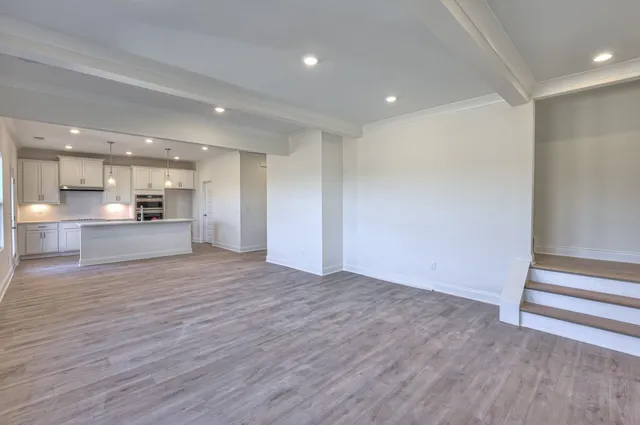 a view of a kitchen with a sink and a refrigerator