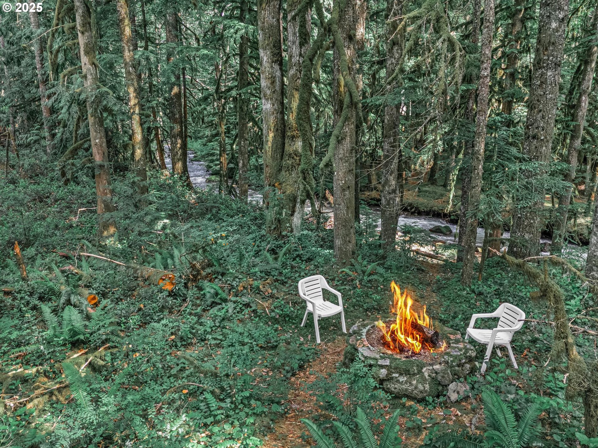 75125 Mt Hood Highway Rhododendron, OR 97049 - Photo 11 of 43 a view of a backyard with table and chairs and a fire pit