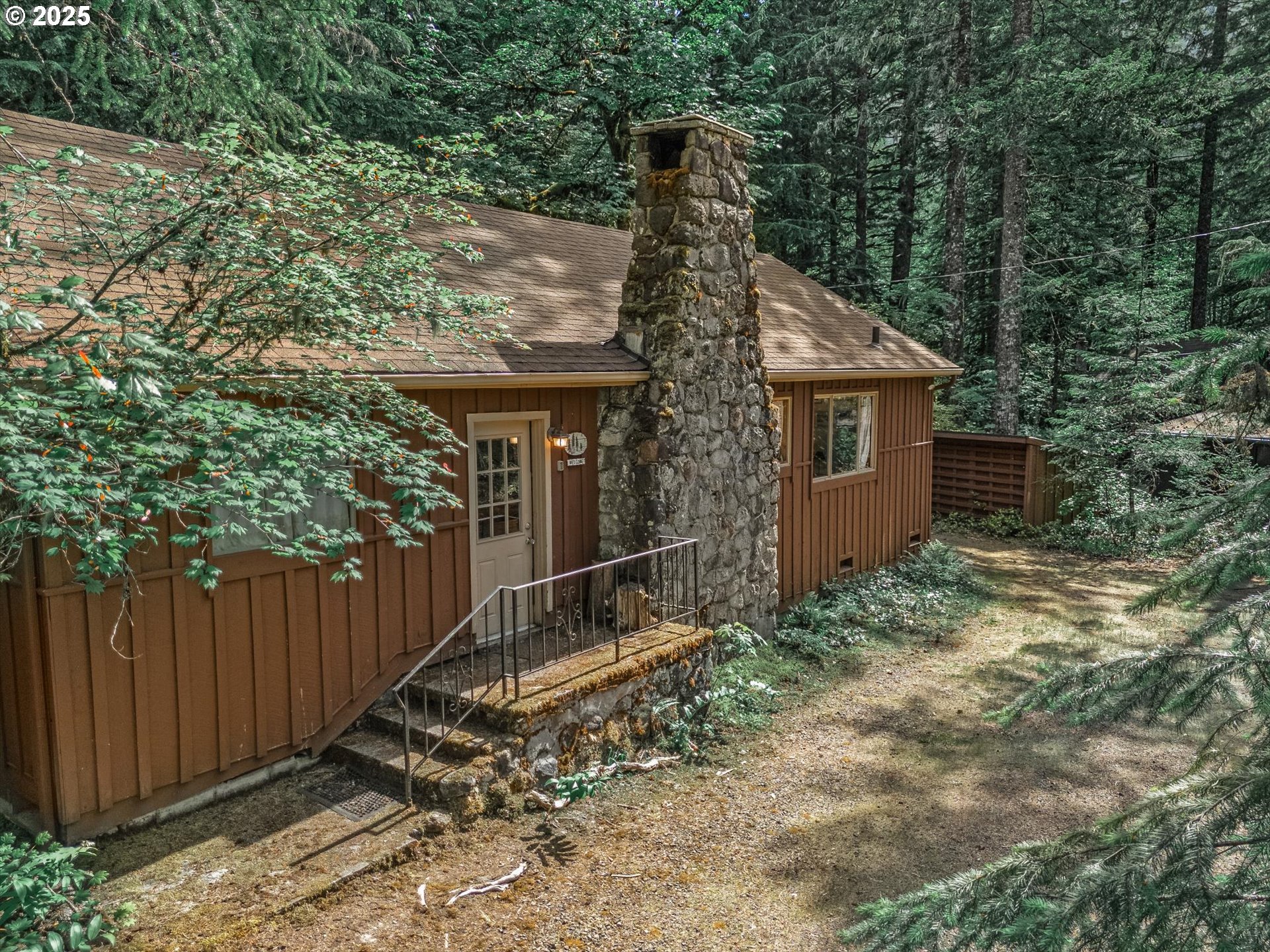 75125 Mt Hood Highway Rhododendron, OR 97049 - Photo 4 of 43 a view of a house with a yard and wooden fence