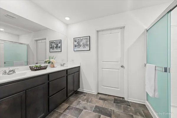 a bathroom with a double vanity sink and a mirror