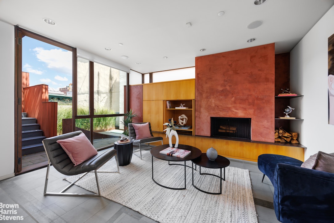 42 Downing Street Manhattan, NY 10014 - Photo 14 of 25 a living room with furniture and a fireplace