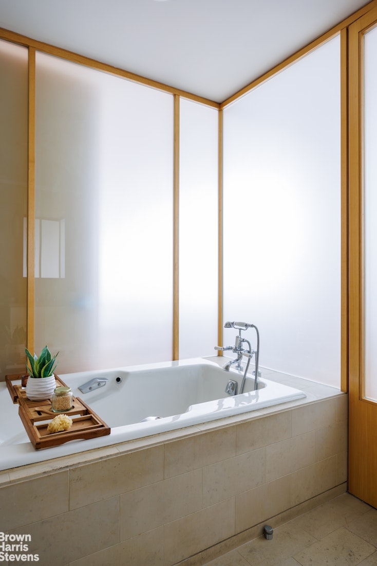 42 Downing Street Manhattan, NY 10014 - Photo 15 of 25 a bathroom with a tub and a sink