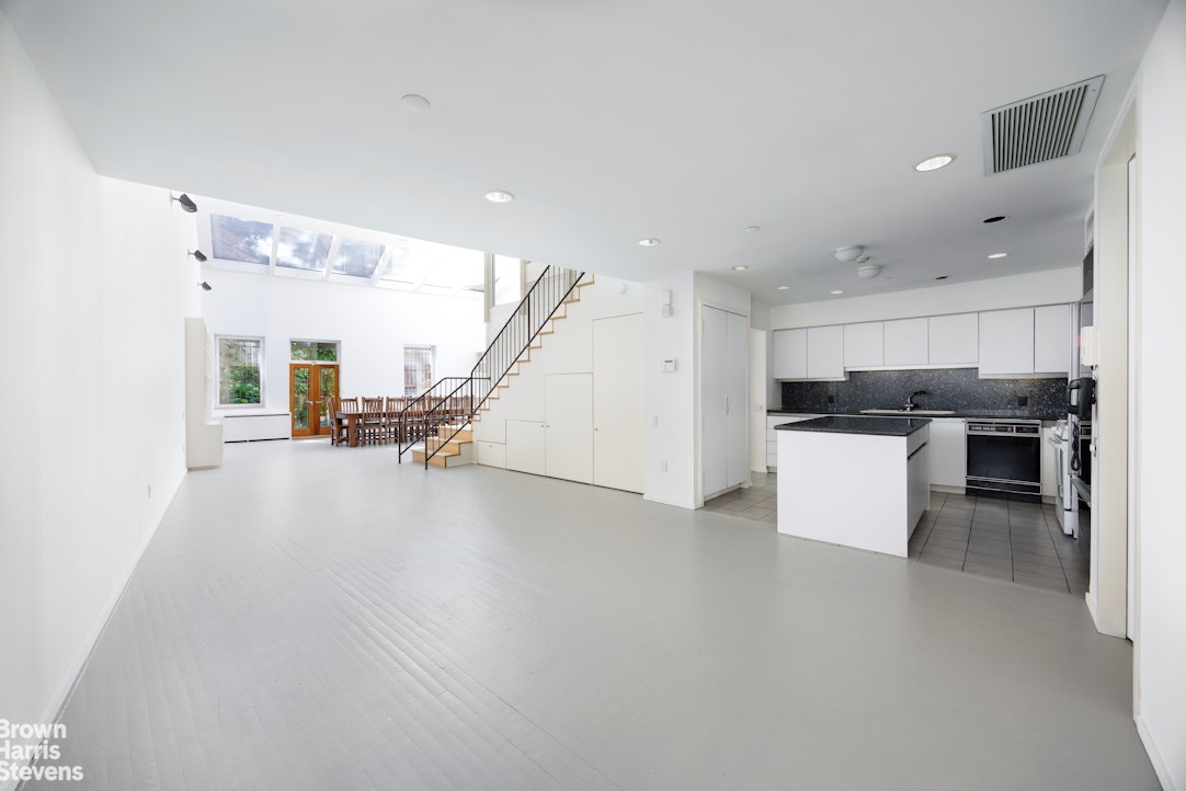 42 Downing Street Manhattan, NY 10014 - Photo 17 of 25 a view of kitchen with furniture and wooden floor