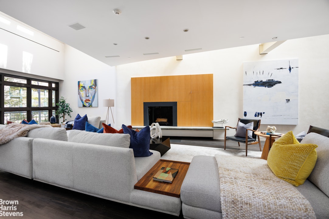 42 Downing Street Manhattan, NY 10014 - Photo 2 of 25 a living room with furniture and a fireplace