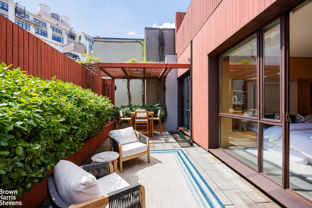 42 Downing Street Manhattan, NY 10014 - Photo 21 of 25 a balcony with table and chairs