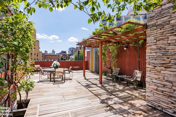a view of a patio with a table and chairs under an umbrella