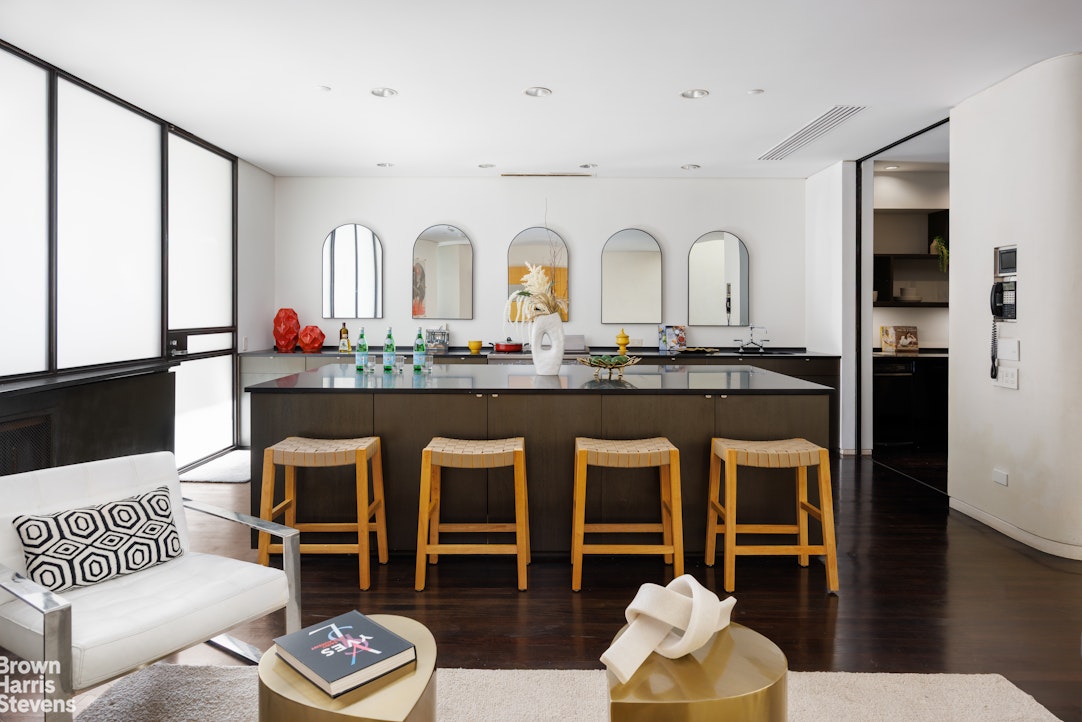 42 Downing Street Manhattan, NY 10014 - Photo 5 of 25 a living room with stainless steel appliances furniture and a large window