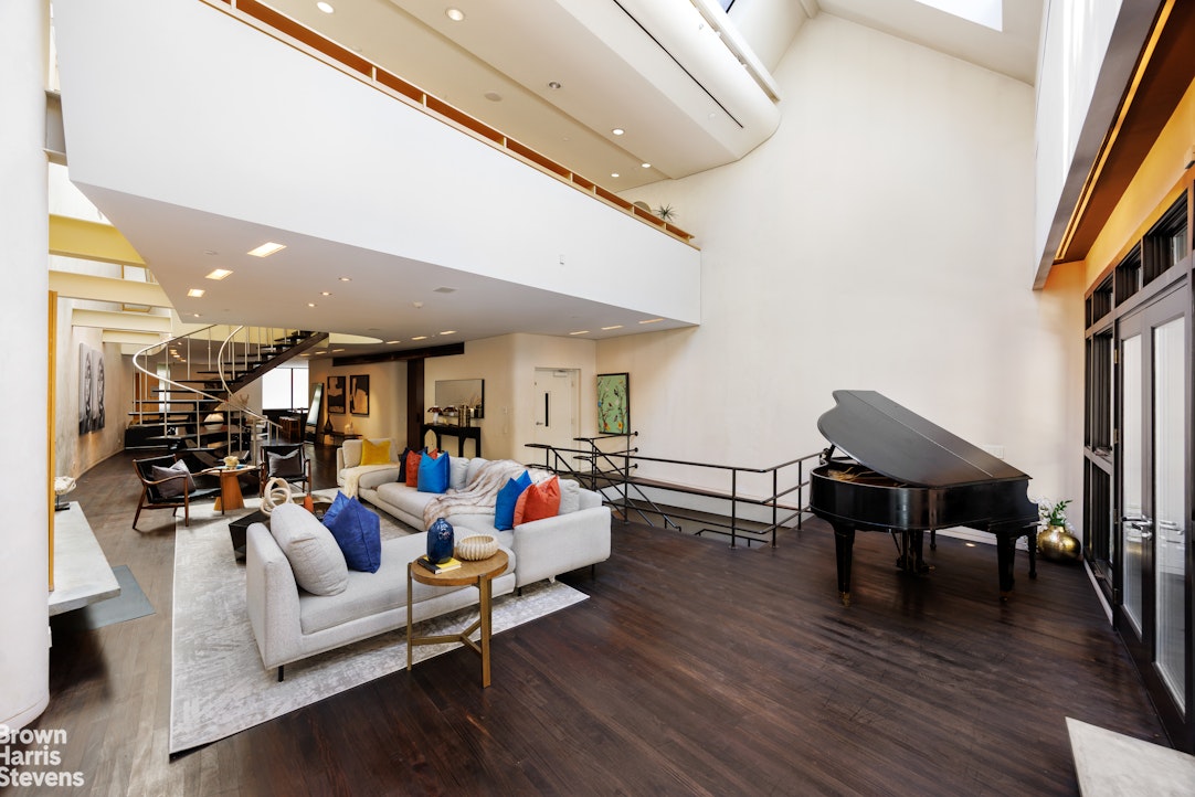 42 Downing Street Manhattan, NY 10014 - Photo 6 of 25 a living room with furniture and wooden floor