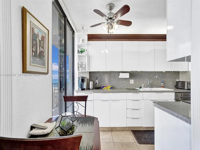 a kitchen with granite countertop a sink and a stove top oven