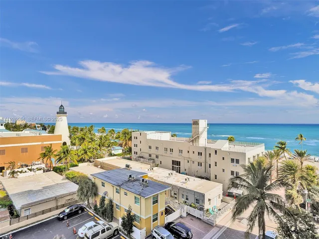 a living room with furniture potted plant and a large window