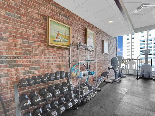 a room with pool table and windows