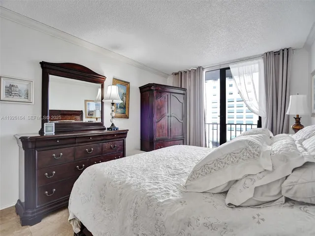 a bedroom with a bed and dresser with mirror