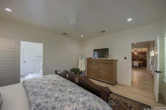a bedroom with a bed and flat screen tv