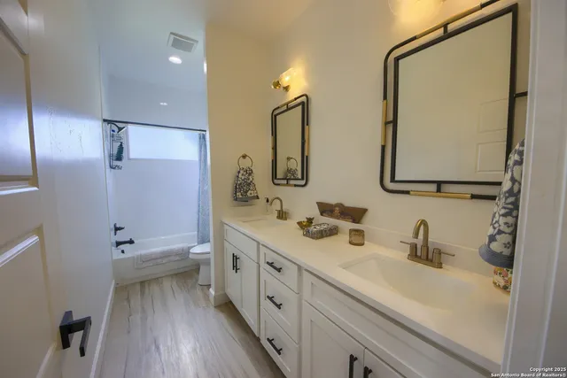 a bathroom with 2 sink and a mirror