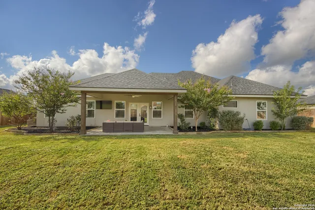a view of a house with swimming pool and a yard