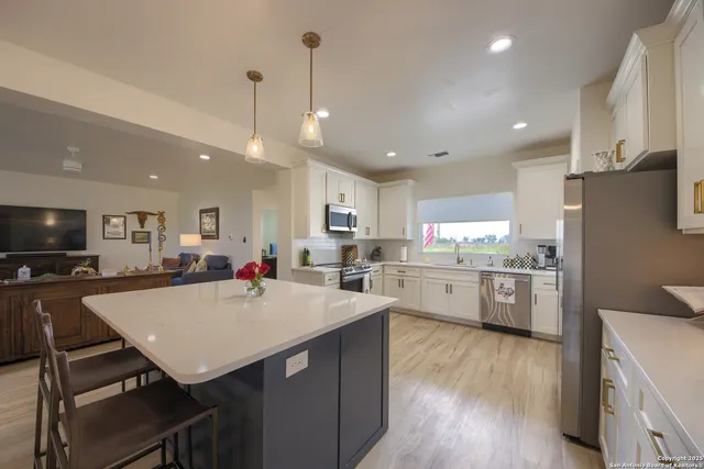a kitchen with a table chairs refrigerator and microwave