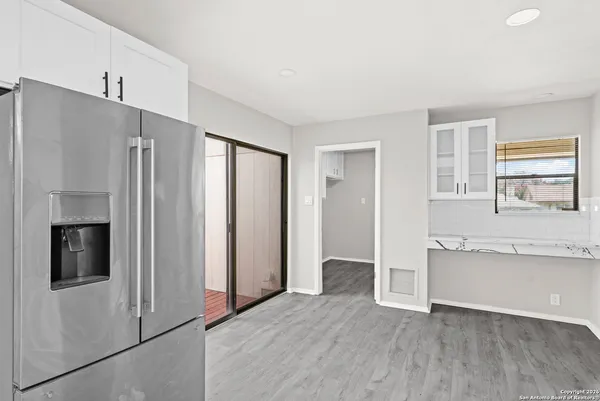 a view of kitchen with stainless steel appliances cabinets and a window