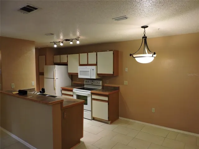 a kitchen with cabinets a sink and appliances